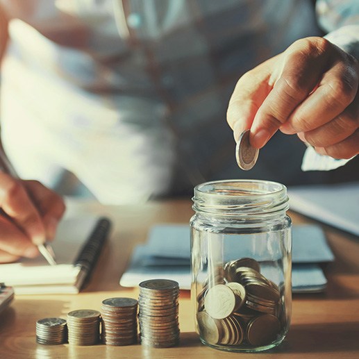 Coins being put into a jar