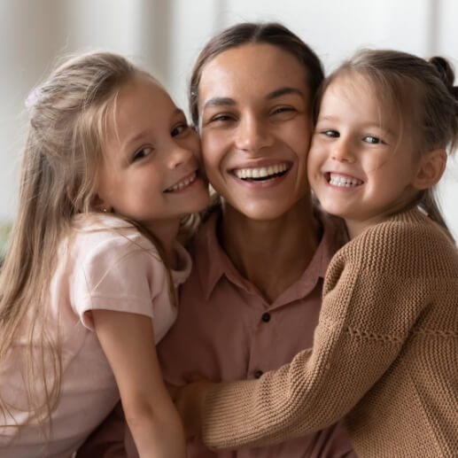 Mother smiling with her two daughters