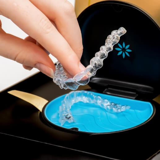 Person placing Invisalign aligners into their storage case