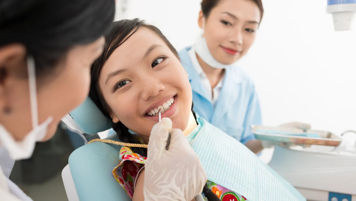 Cosmetic dentist treating a patient